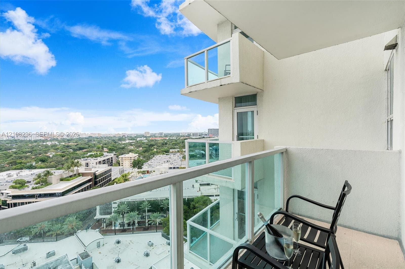 Private balcony featuring glass panel railings and expansive overhead perspective