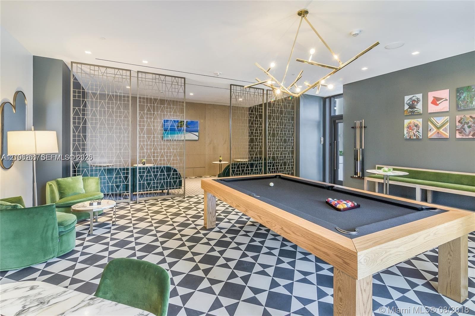 Geometric patterned tile flooring, intricate metal latticework room dividers, custom branched-arm chandelier, recessed ceiling lighting, and built-in wall-mounted cue rack