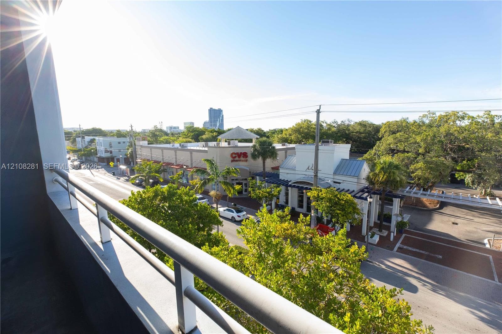Exterior balcony featuring a metal railing and urban landscape