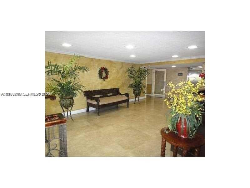 Large-format tile flooring, recessed ceiling lighting, and textured wall finishes