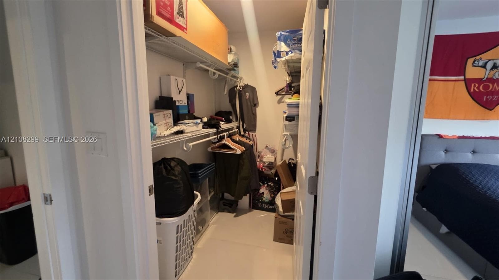 Walk-in closet featuring multi-tiered wire shelving and integrated hanging rods