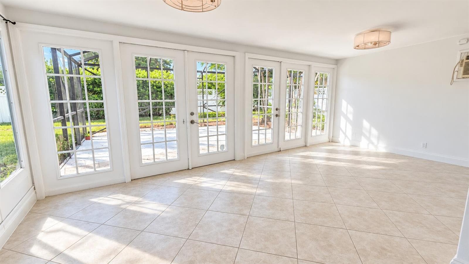 Sunlit Modern Sunroom with French Doors