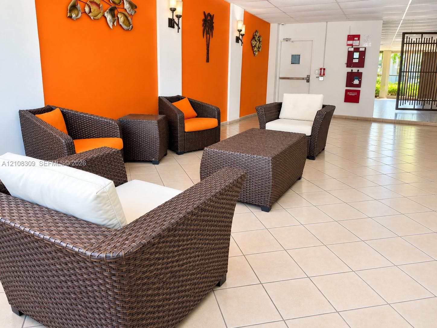 Common area featuring diagonal ceramic tile flooring, wall-mounted sconce lighting, and decorative wall accents
