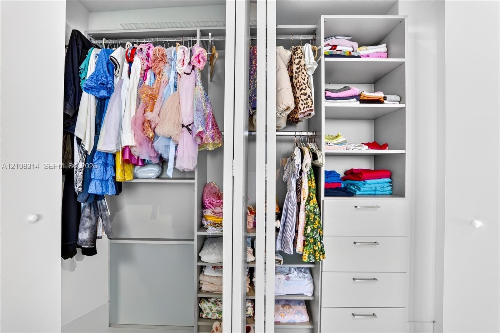 Built-in closet system featuring dual hanging rods, four integrated storage drawers, and multiple open-concept shelving units with a matte white finish