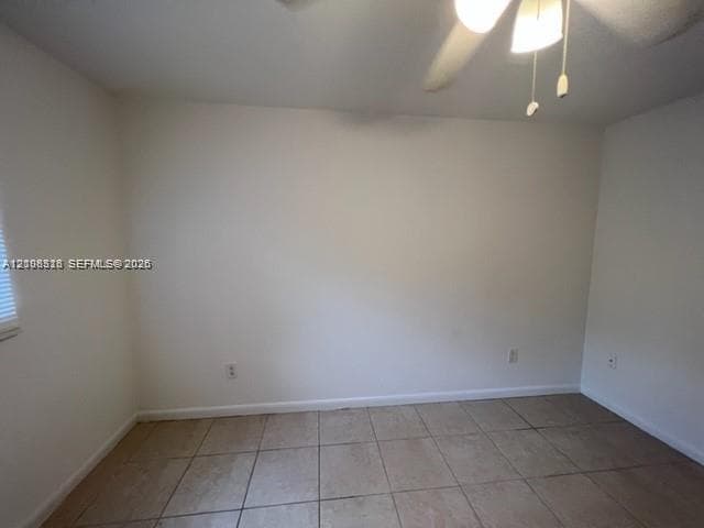 Neutral-toned ceramic tile flooring, ceiling fan with integrated light fixture, and horizontal blind window treatment