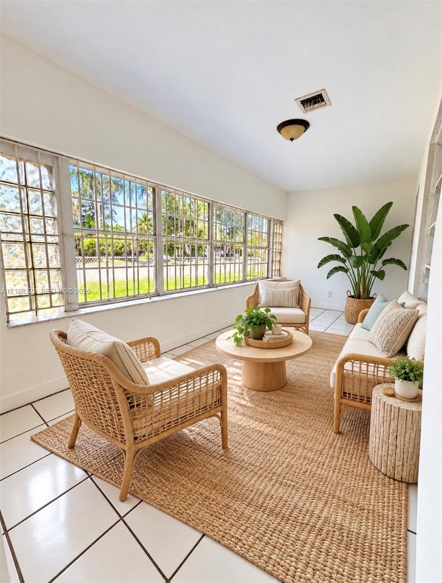 Enclosed space featuring large, grid-patterned casement windows, white ceramic tile flooring, and a flush-mount ceiling fixture