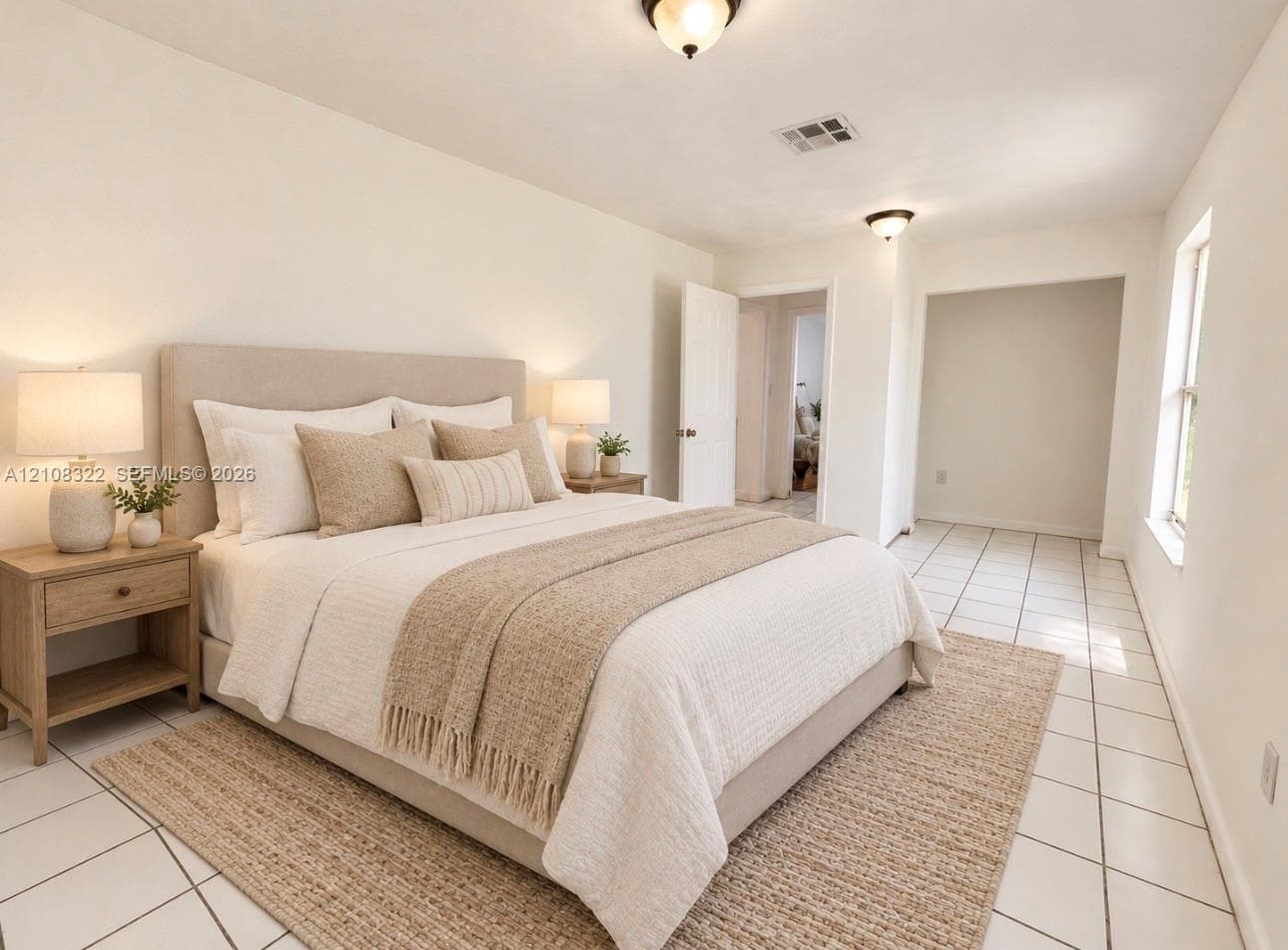 Neutral-toned interior space featuring light-colored ceramic tile flooring, dual flush-mount ceiling light fixtures, and natural light via a single-pane window
