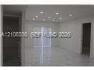 Interior space featuring recessed lighting, polished stone flooring, and sliding glass doors