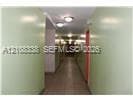 Interior corridor featuring tile flooring and flush-mount ceiling lighting