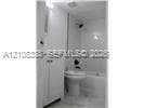 Bathroom featuring white cabinetry, an integrated sink basin, a tub-shower combination, and polished tile flooring