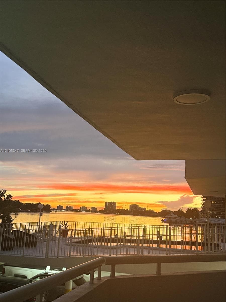 Covered terrace  recessed ceiling lighting, and expansive water backdrop