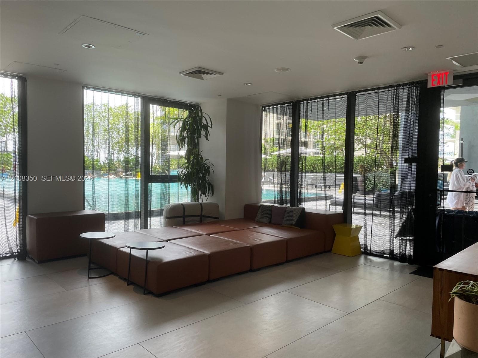 Common area featuring floor-to-ceiling windows, large-format tile flooring, and recessed ceiling lighting
