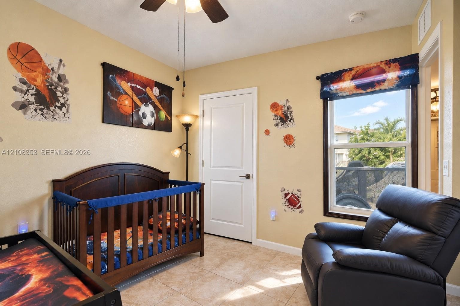 Neutral-toned room featuring tile flooring, a multi-panel door, and a single-hung window with dark trim