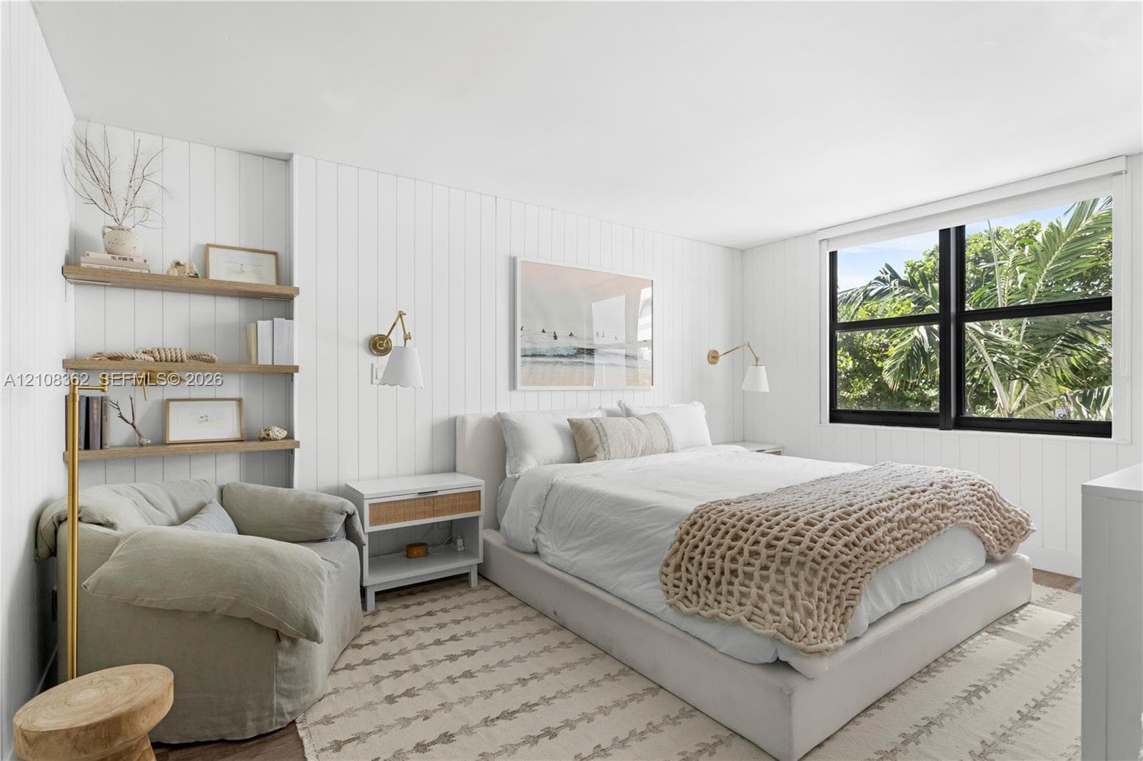 Vertical tongue-and-groove wall paneling, built-in recessed shelving, wall-mounted swing-arm light fixtures, and a multi-pane window