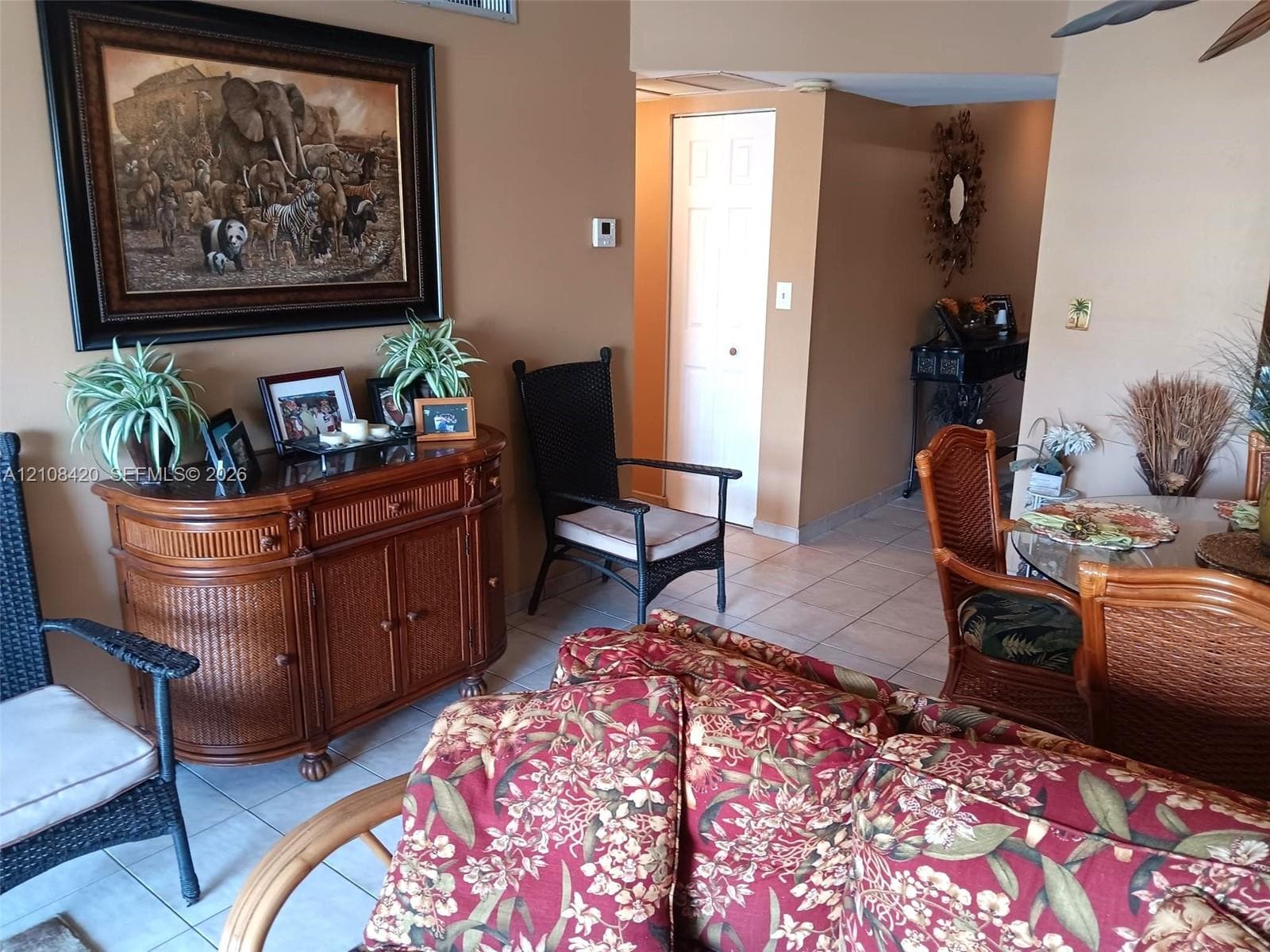 Interior space featuring neutral-toned walls, tile flooring, and a six-panel interior door