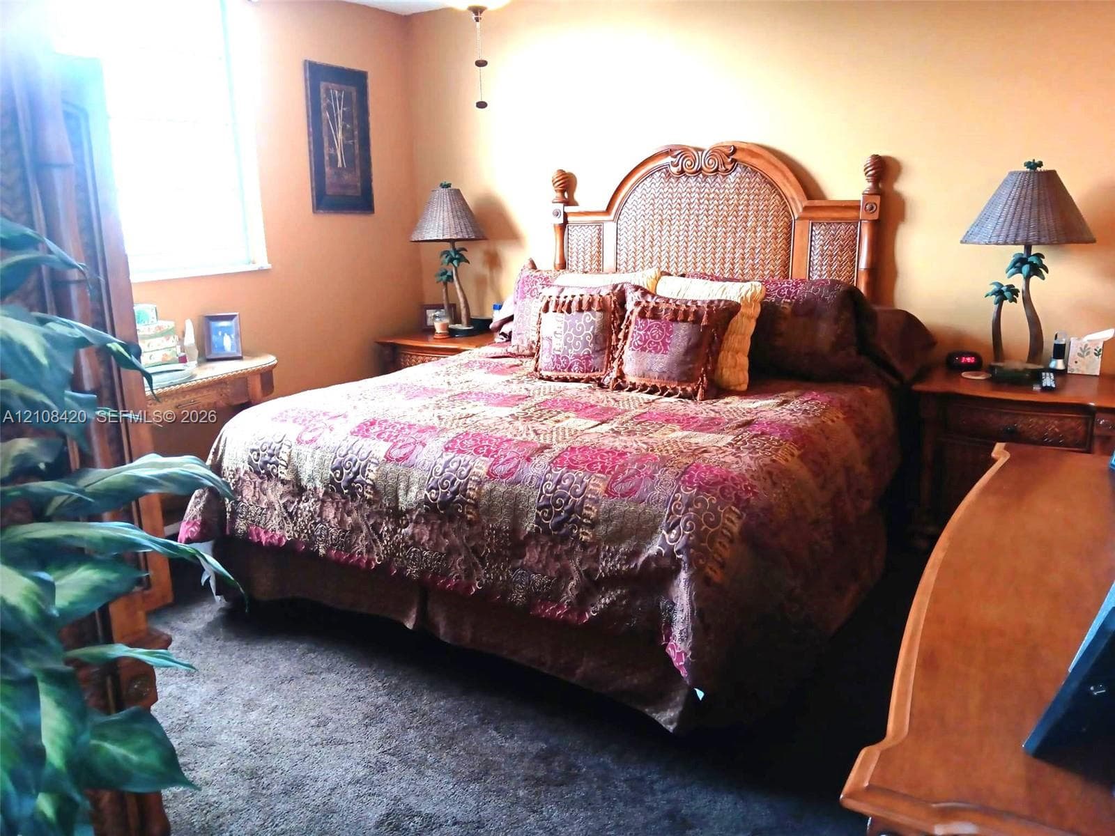 Bedroom featuring neutral wall paint, carpeting, and a multi-pane window