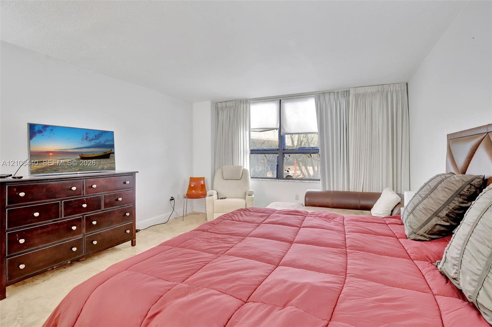 Spacious room featuring large windows, neutral wall finishes, and polished hard-surface flooring