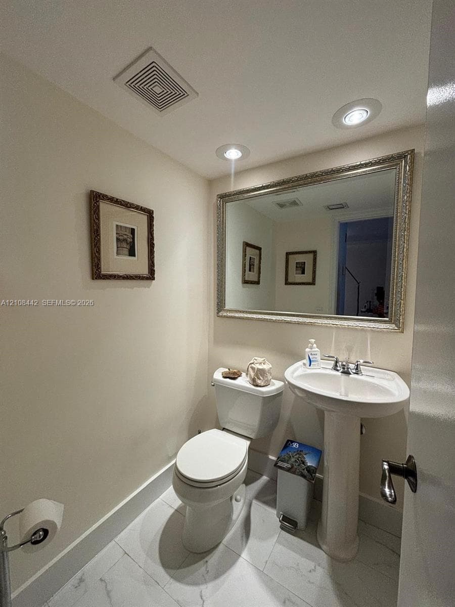 Room featuring white interior walls, plantation shutters, a ceiling fan, and multi-lite French doors
