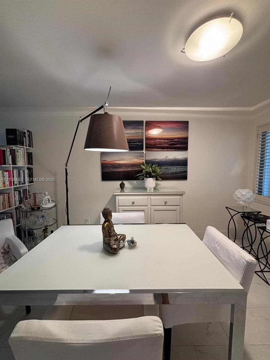 Built-in floor-to-ceiling shelving, light-colored tile flooring, flush-mount elliptical ceiling lighting, and window shutters
