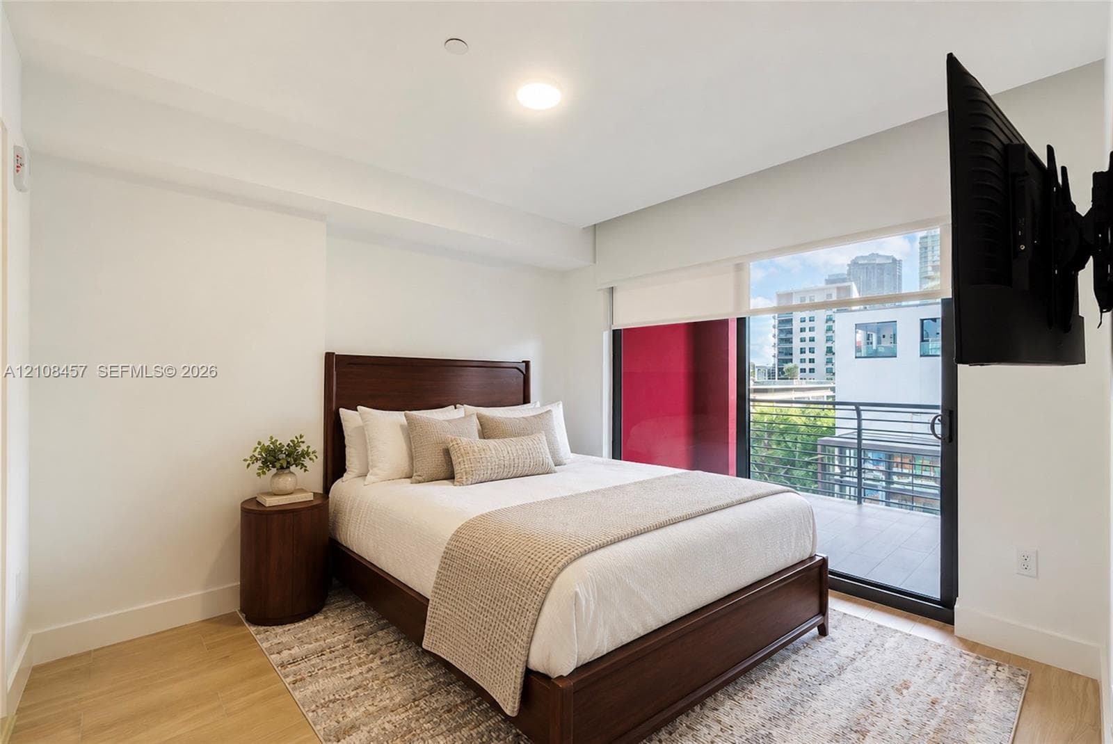 Bedroom featuring wood-finish flooring, recessed lighting, and a sliding glass door providing access to a private balcony