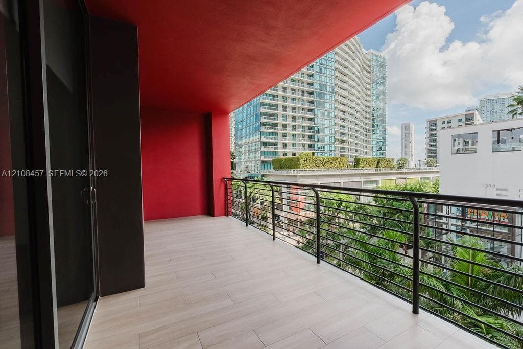 Covered balcony featuring tile flooring and a horizontal rail system