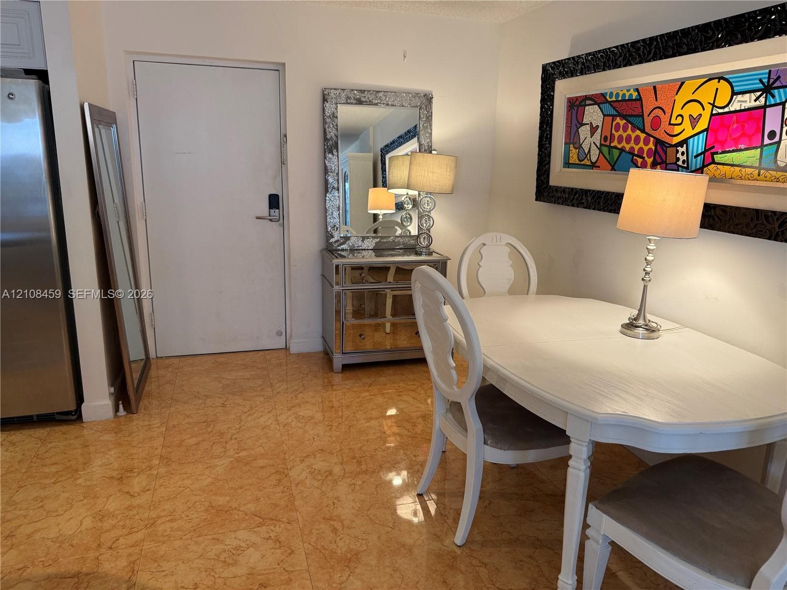 Polished stone flooring throughout the area and a high-contrast decorative wall accent