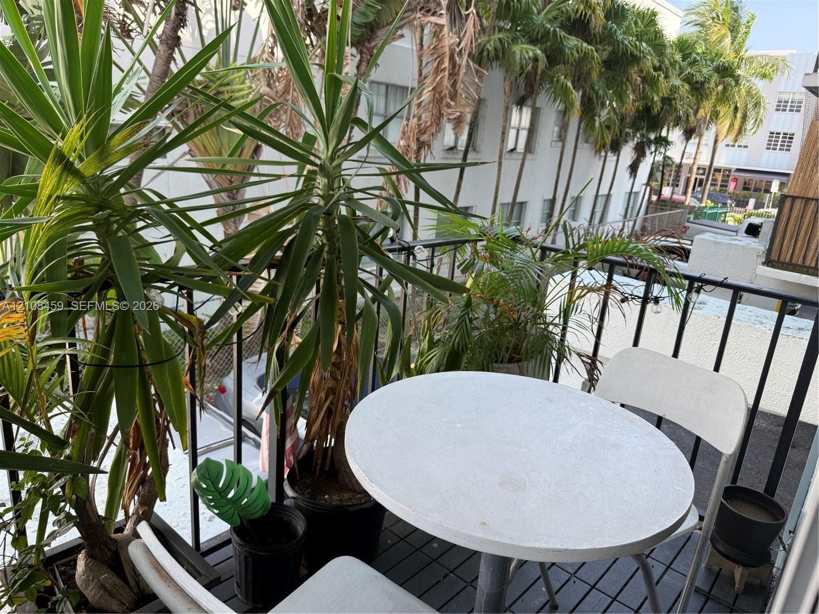 Outdoor balcony featuring black metal railings and slat-style flooring