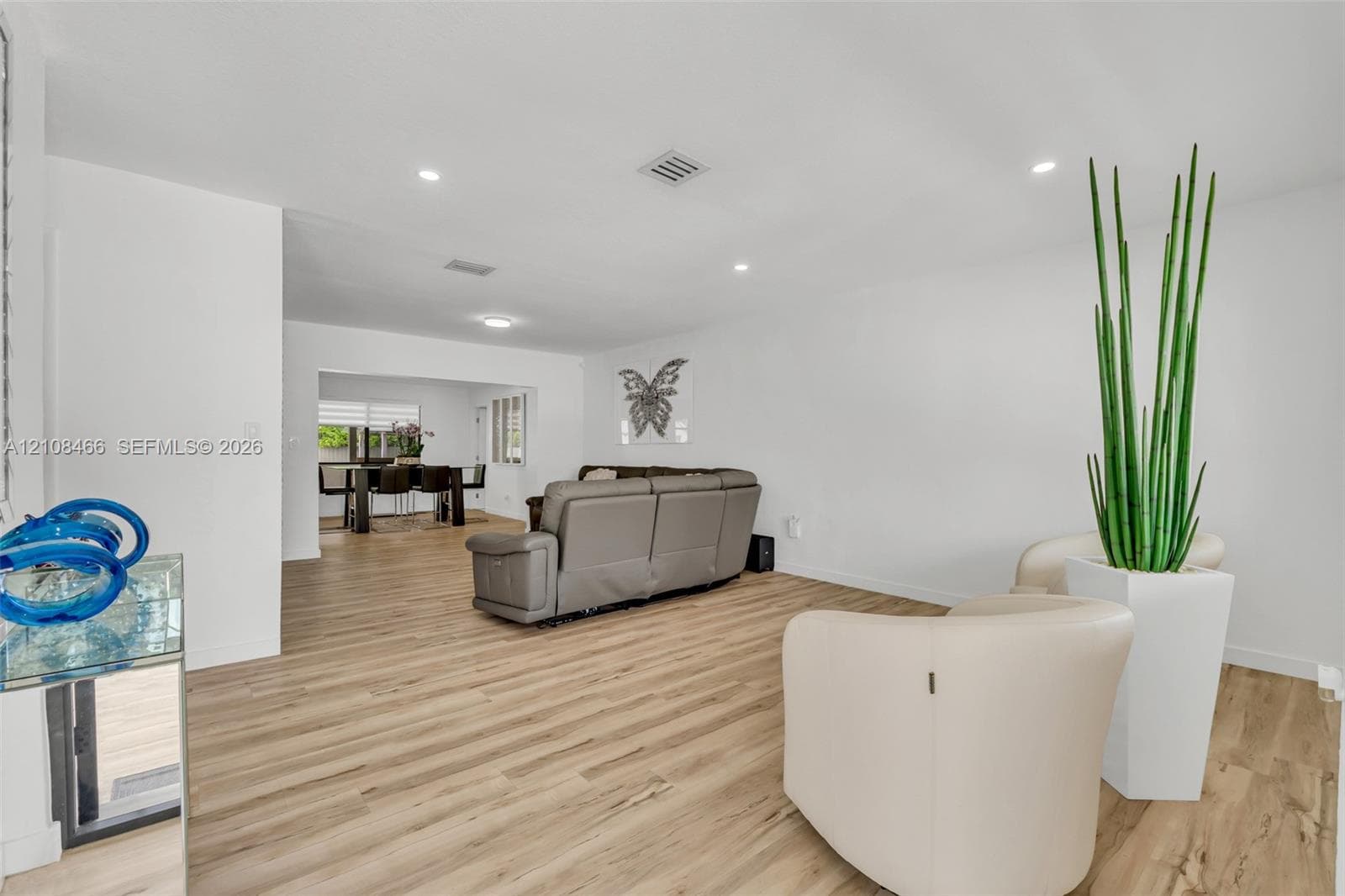 Open-concept interior featuring light wood-finish flooring and recessed lighting