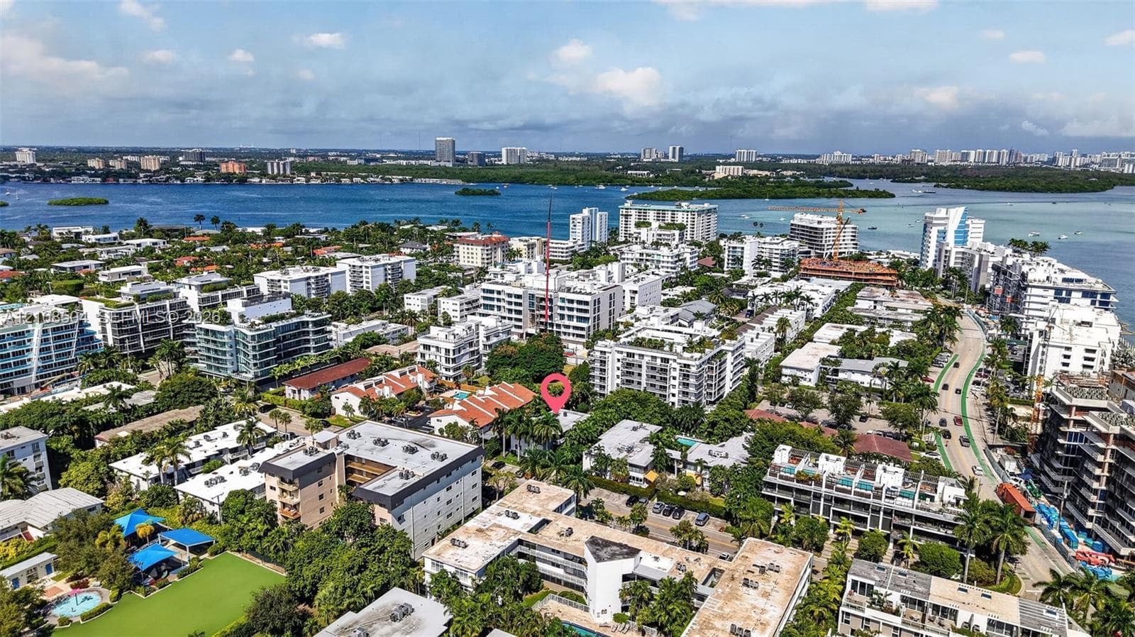 Aerial perspective of the property location, characterized by mature tropical landscaping, dense residential density, and proximity to coastal waters
