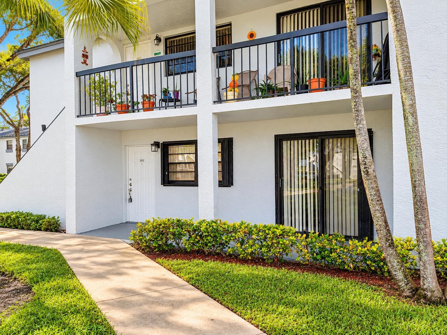 Sunny Condo Entrance with Tropical Lands