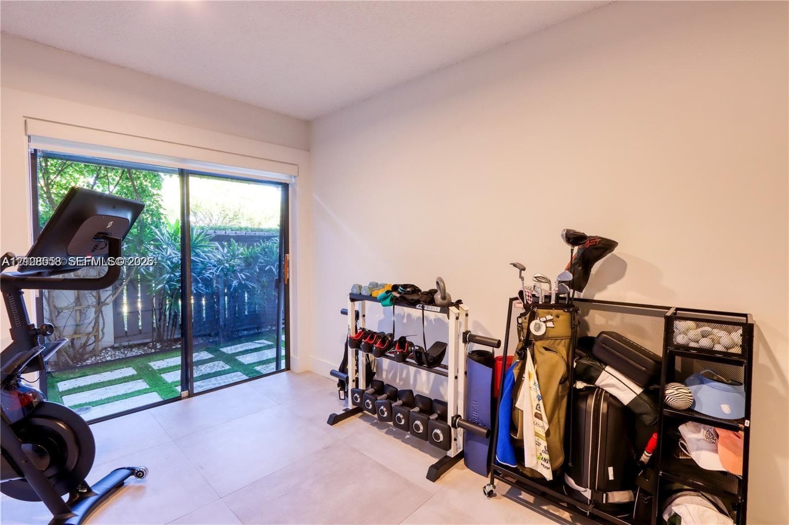 Large format tile flooring and sliding glass doors providing outdoor access
