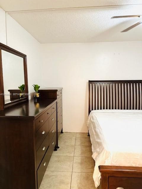 Neutral-toned tile flooring and ceiling-mounted fan