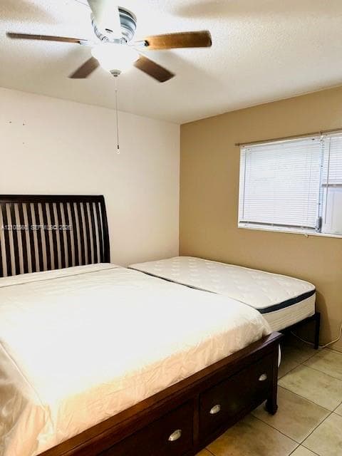 Room featuring tile flooring, neutral wall tones, and a ceiling fan with integrated lighting