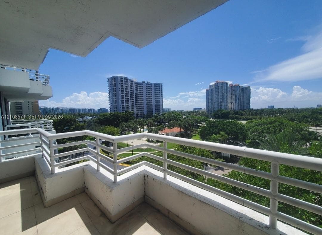 Private balcony featuring tile flooring and a white powder-coated metal railing