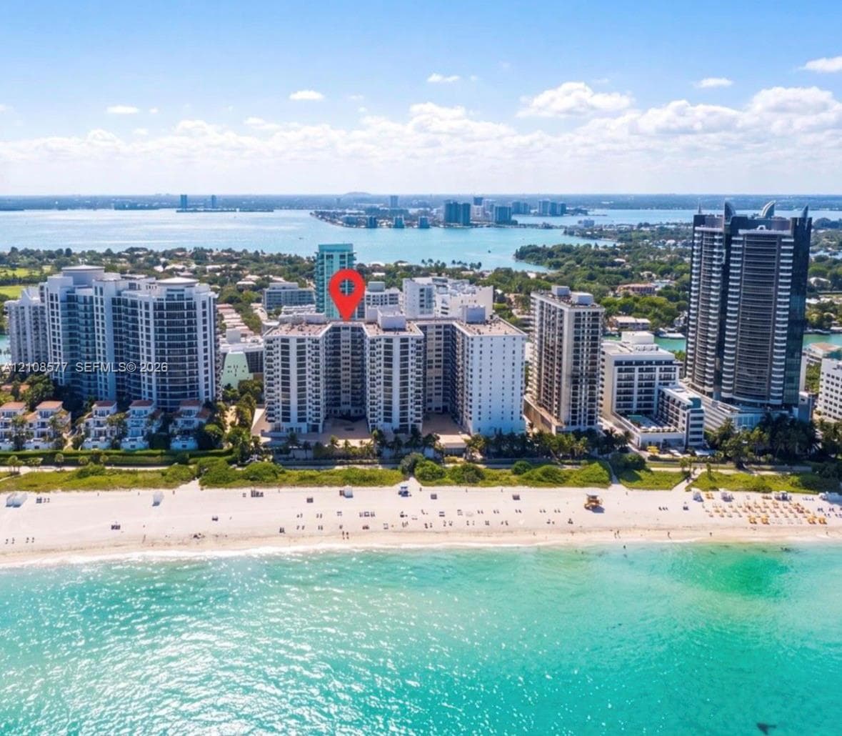 High-rise residential building featuring immediate beach access and a coastal shoreline location