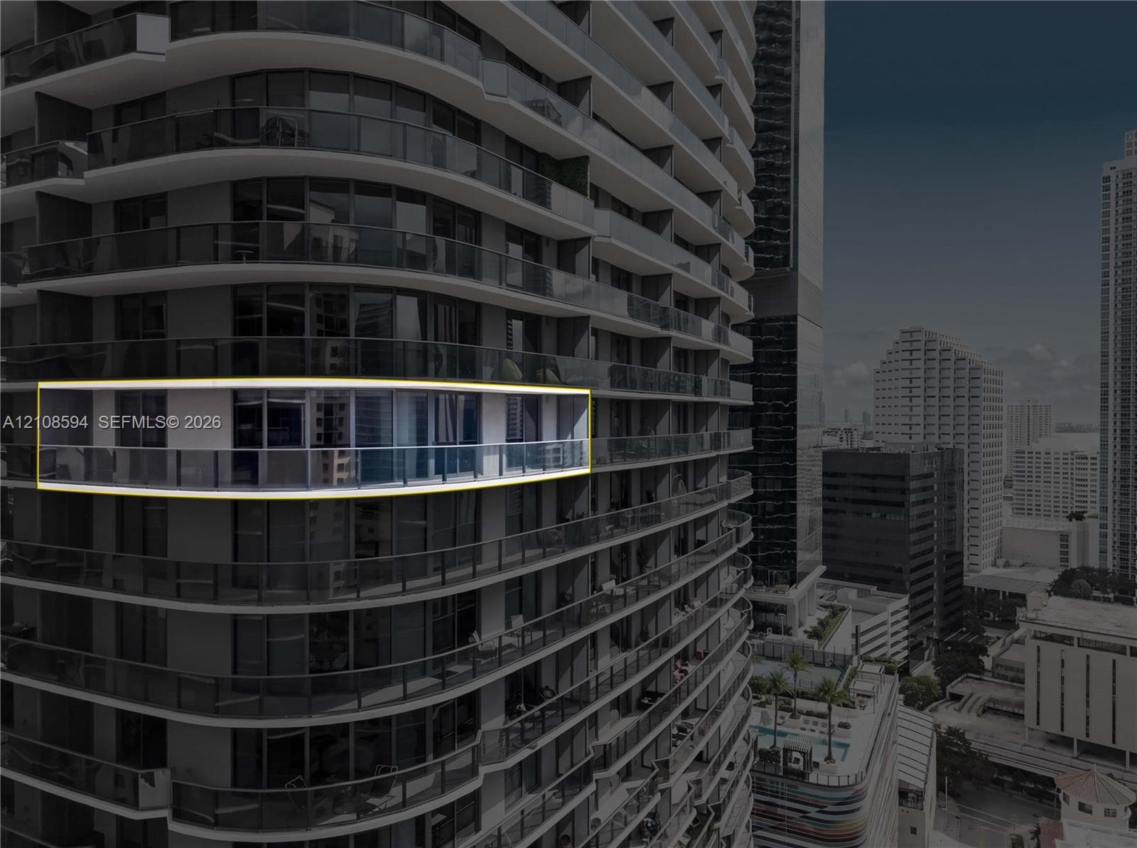 High-rise exterior featuring curved structural balconies with glass railings and floor-to-ceiling glass paneling