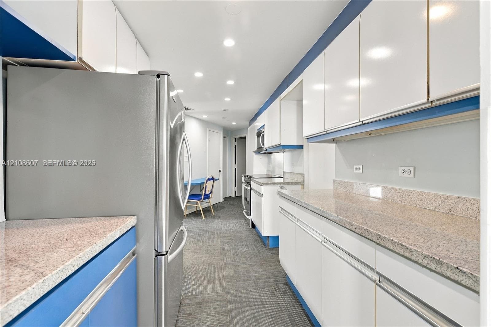 Kitchen featuring white cabinetry, stone-finish countertops, stainless steel refrigerator, recessed lighting, and patterned floor tiling