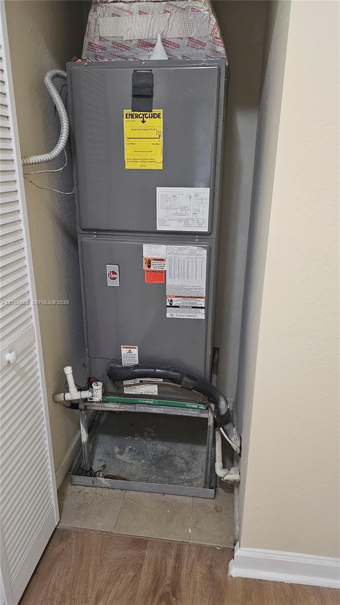 High-efficiency HVAC furnace unit featuring a gray metal housing and rigid pipe connections