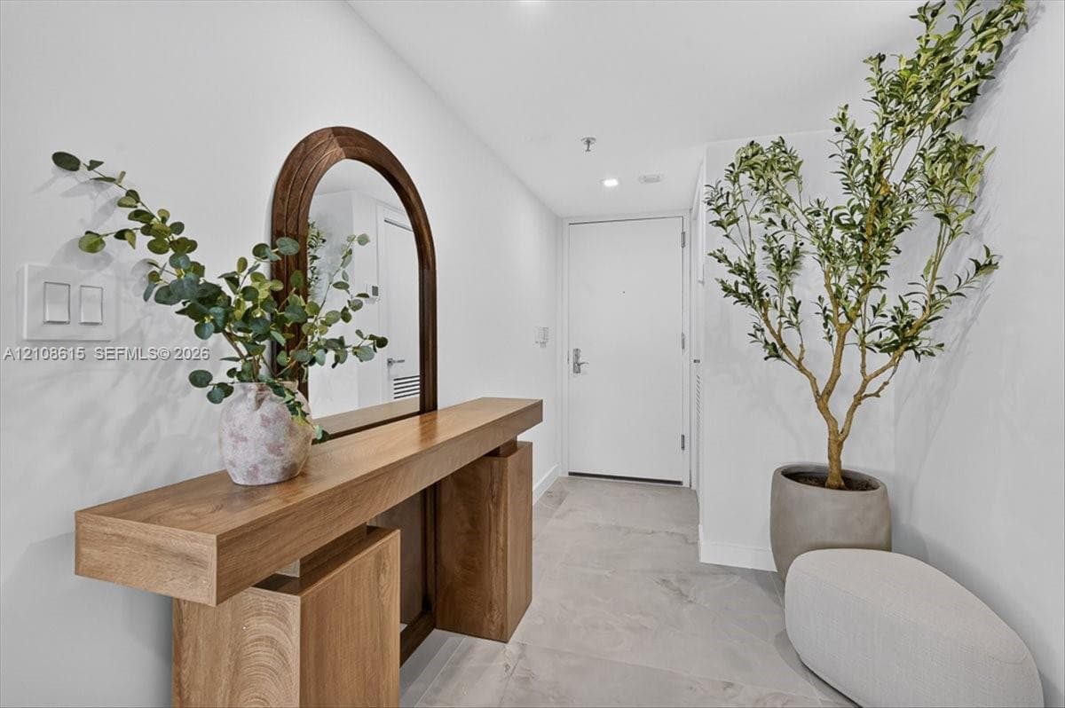 Entry featuring large-format tile flooring and recessed ceiling lighting
