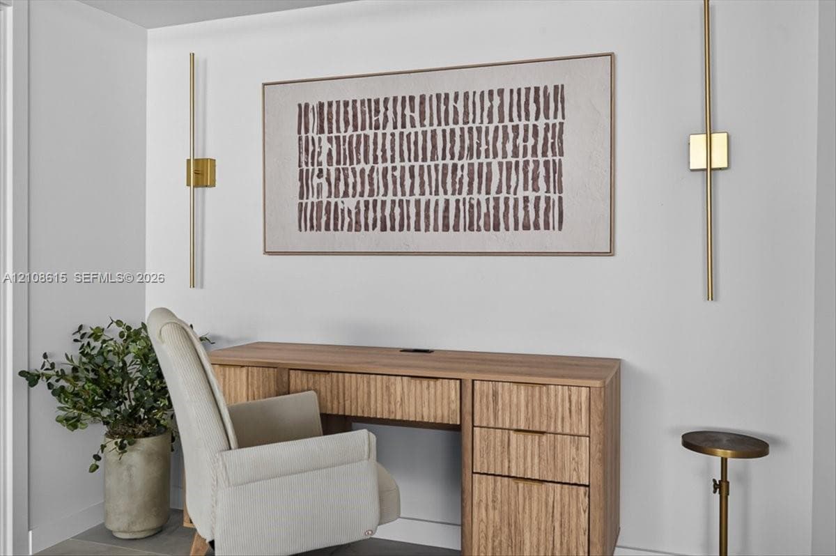 Vertical brass wall-mounted light fixtures with a minimalist aesthetic