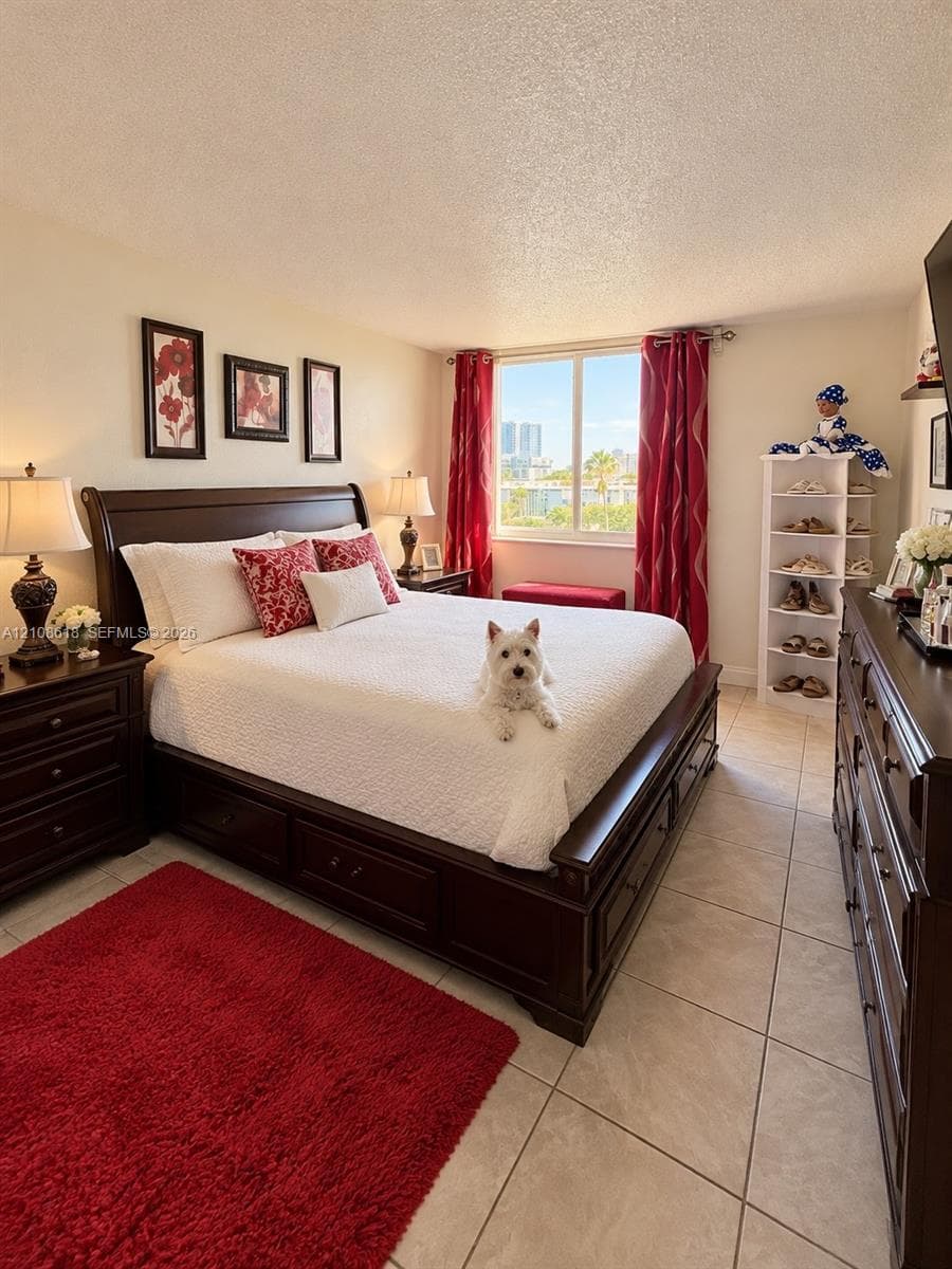 Neutral-toned ceramic tile flooring and a large, centrally positioned window allowing for natural illumination