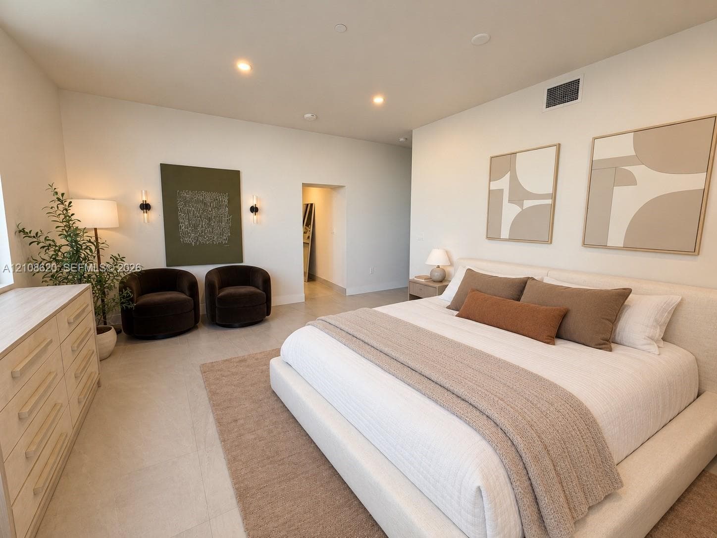 Neutral-toned interior featuring high ceilings with recessed lighting and large-format tile flooring