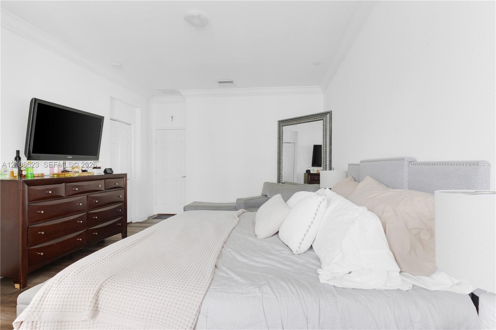 Spacious interior featuring crown molding, recessed lighting, and wood-finish flooring