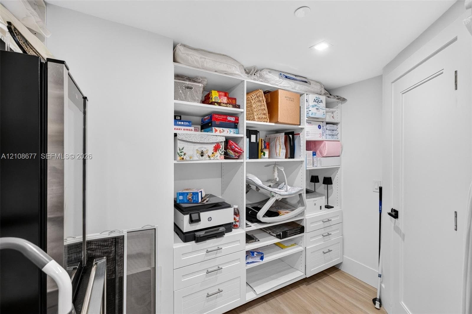 One angle of the walk in closet off bedroom #3 w/ custom built ins. Closet is very large wraps around into a large L shape