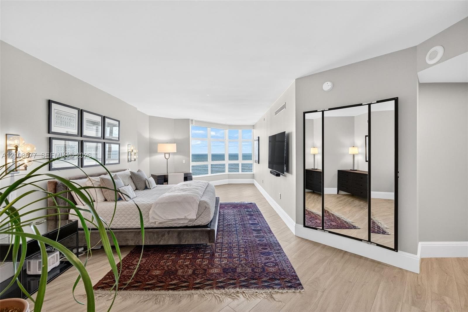 Wood look plank porcelain flooring, floor-to-ceiling bay windows, and a multi-panel mirror dressing area. This is said to be the only unit in the building with a built in primary sitting area (instead of small balcony space). Original developer enclosed the space for first owner.