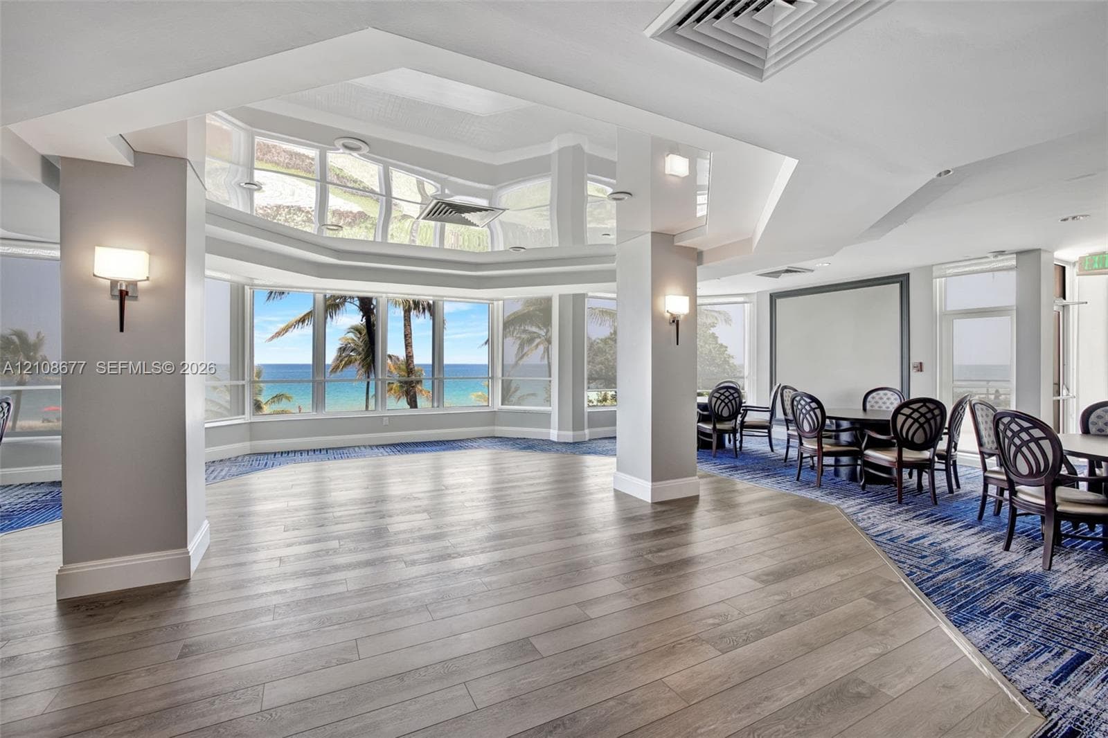 Community Room w/ floor-to-ceiling panoramic windows, dance floor under reflective ceiling
