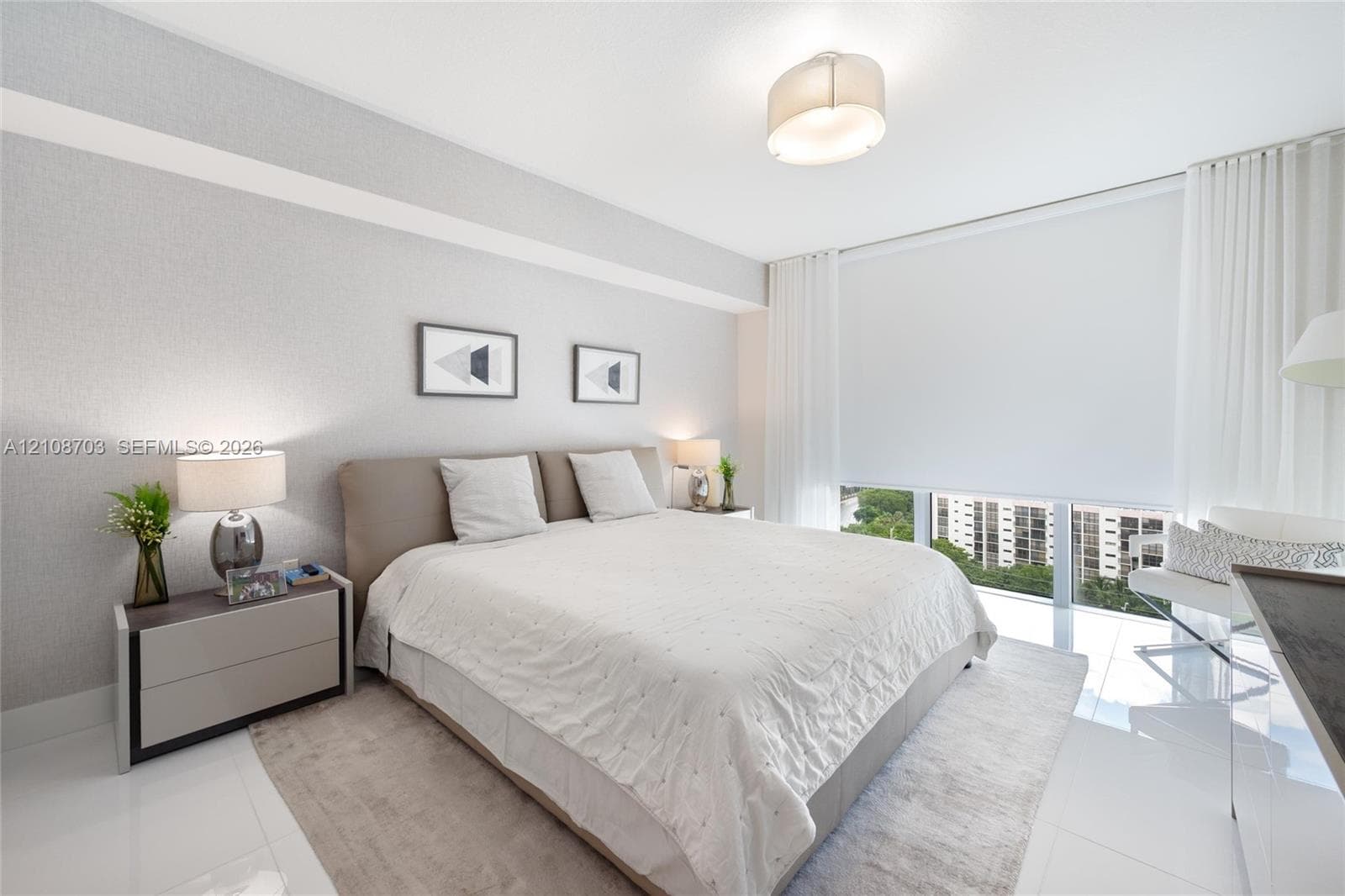 Floor-to-ceiling windows featuring automated roller shades, gloss-finish tile flooring, neutral wall texturing, and a modern drum-style flush-mount ceiling light fixture