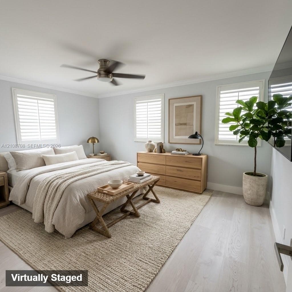 Wood-finish flooring, white plantation shutters, and a central ceiling fan