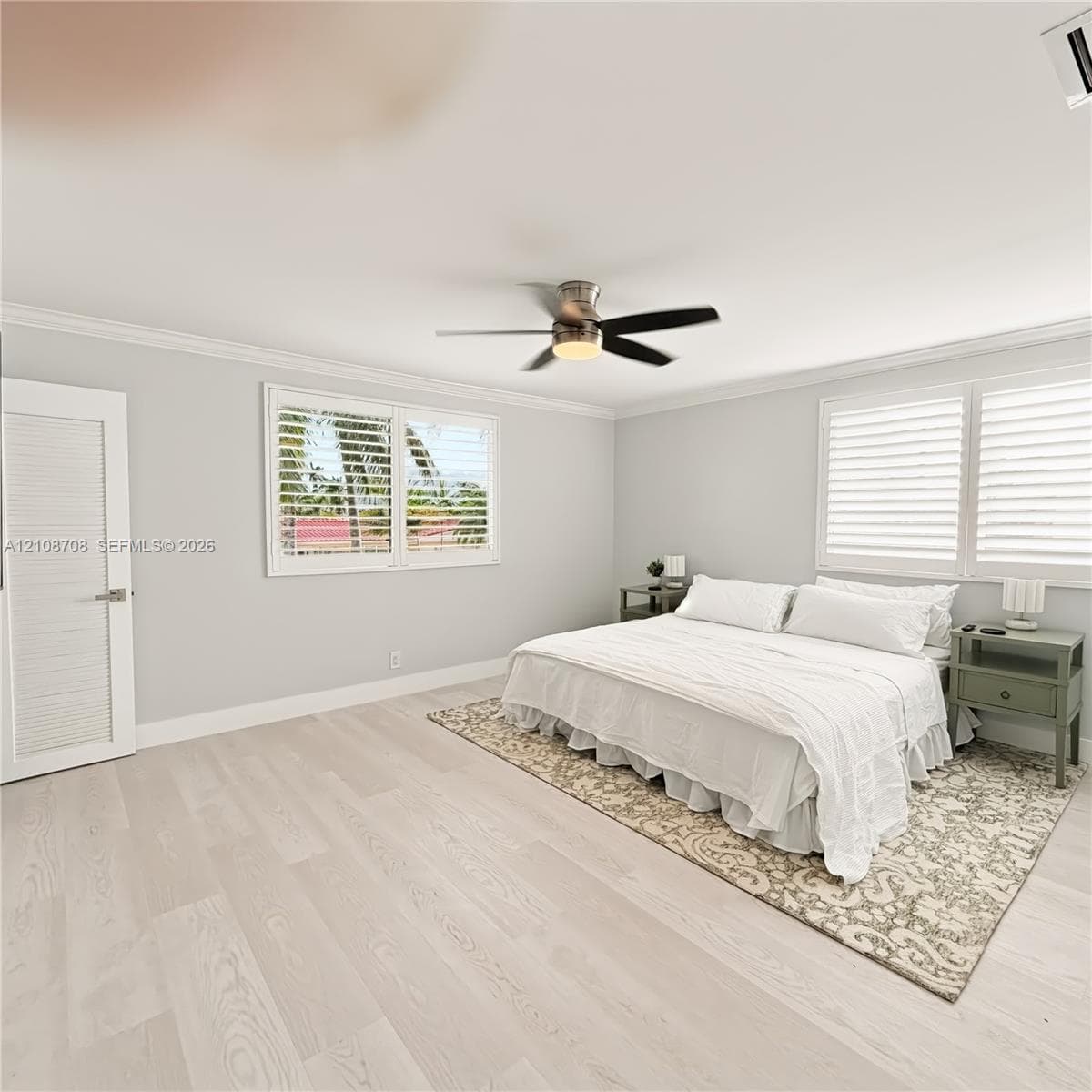 Bedroom with king bed and plantation shutters