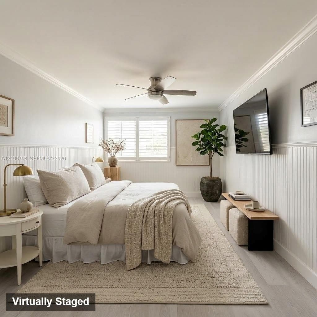 Room featuring beadboard wainscoting, crown molding, light-toned wood-finish flooring, a ceiling fan with integrated lighting, and plantation shutters